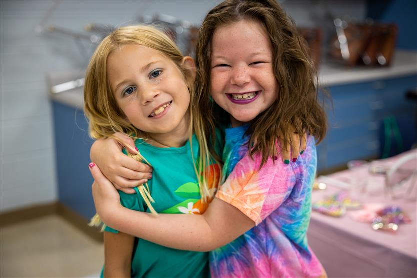 Two girls hug